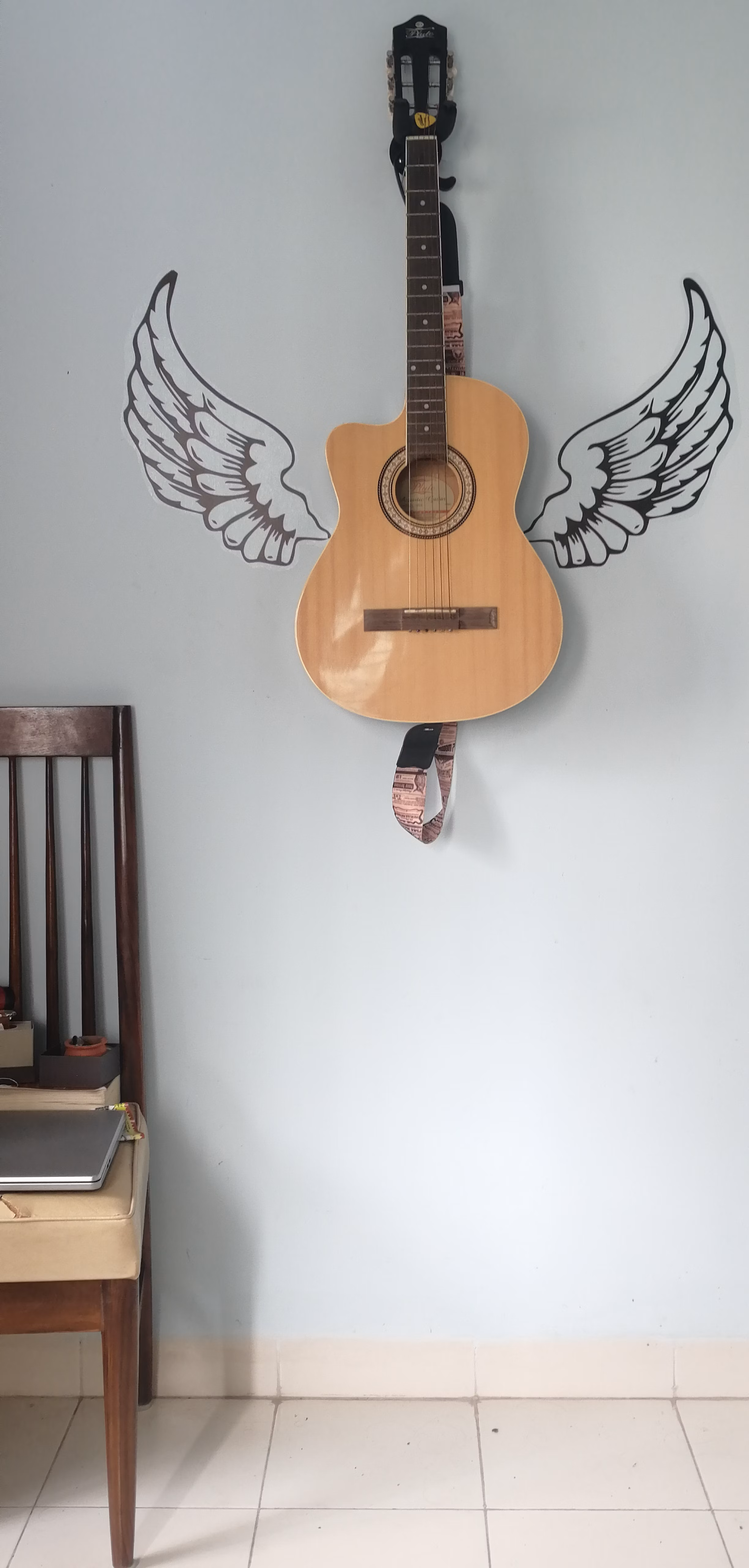 Desk setup with guitar and notebook for songwriting