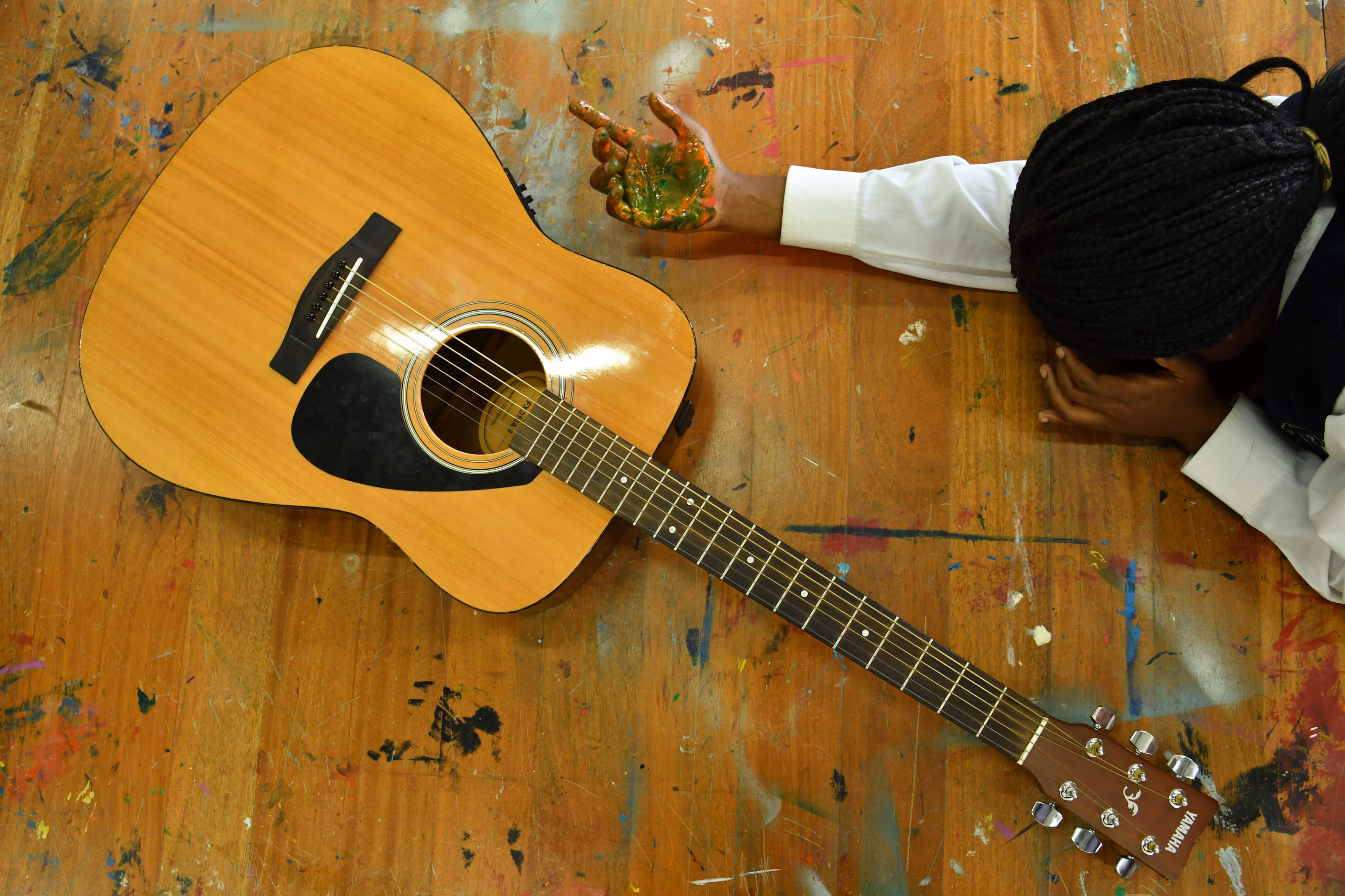 Acoustic and electric guitars in warm studio lighting
